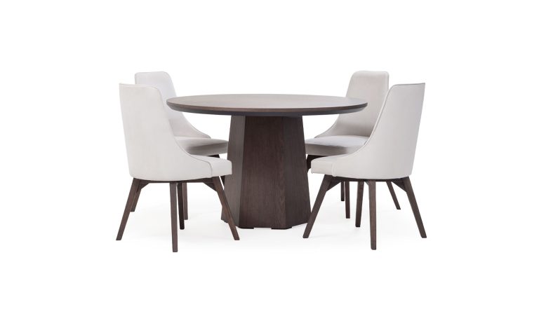 Mesa Comedor Milano redonda con 4 sillas Vela de la marca Aristas, vista en X. La mesa presenta una superficie elegante, sostenida por una base central en madera color Chocolate. Las sillas Vela tienen un estilo elegante y un acabado en tela suave.