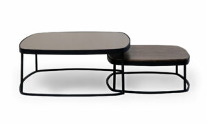 Vista lateral de las Mesas Centro Lisboa Vidrio Madera x2 de Aristas. Este conjunto combina un diseño moderno y funcional, una mesa, con una superficie en espejo color humo y la otra con acabado en madera. Las bases de ambas son delgadas y metálicas, presentando un estilo elegante y contemporáneo.