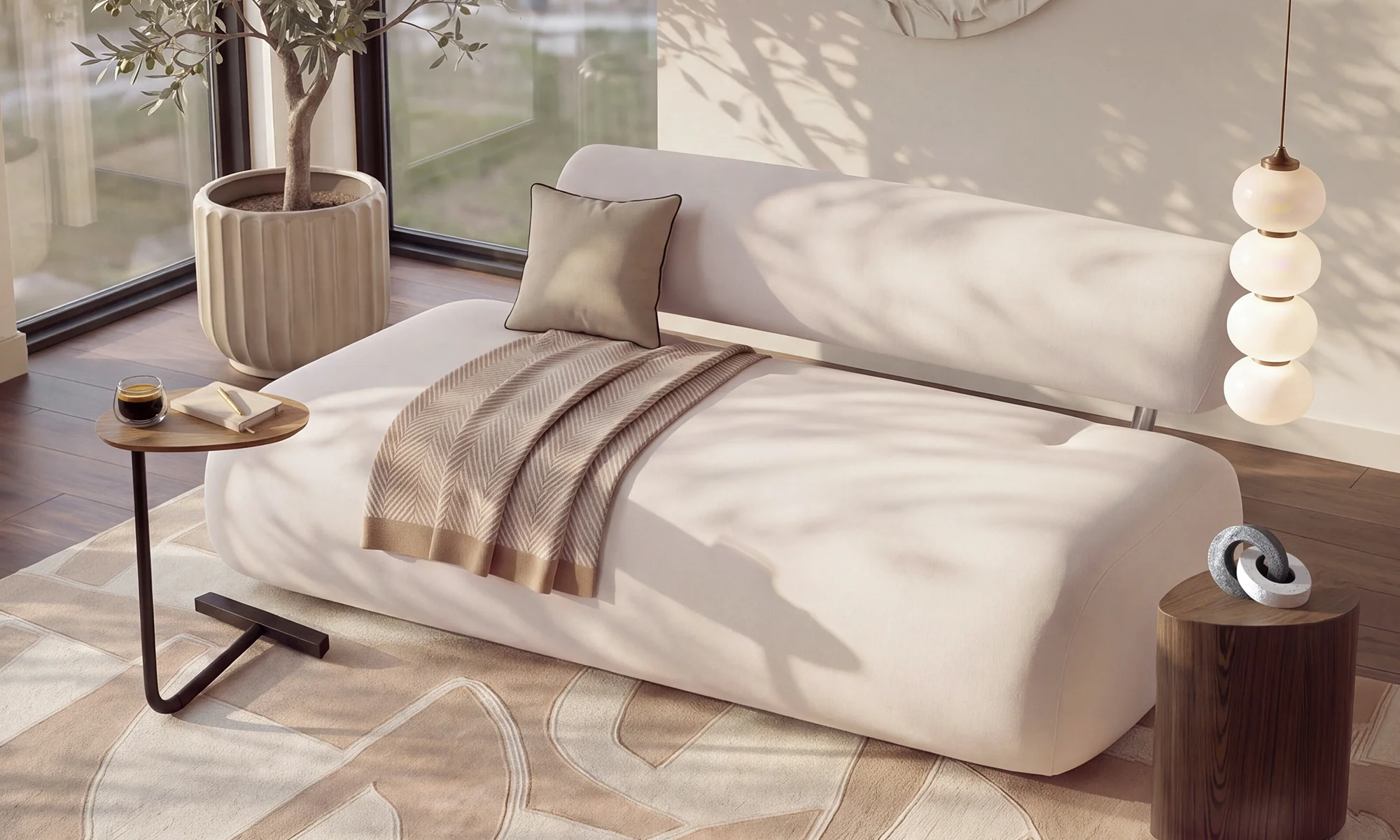 Sofá blanco de líneas suaves con manta beige, mesa auxiliar y lámpara colgante en un rincón de estudio y descanso